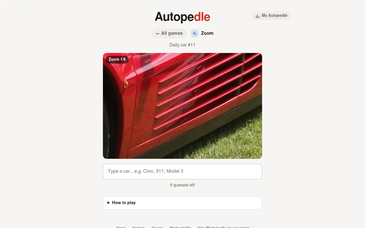Autopedle Zoom: a close-up of a red car's side strakes at zoom 1 of 6, with the guess box below
