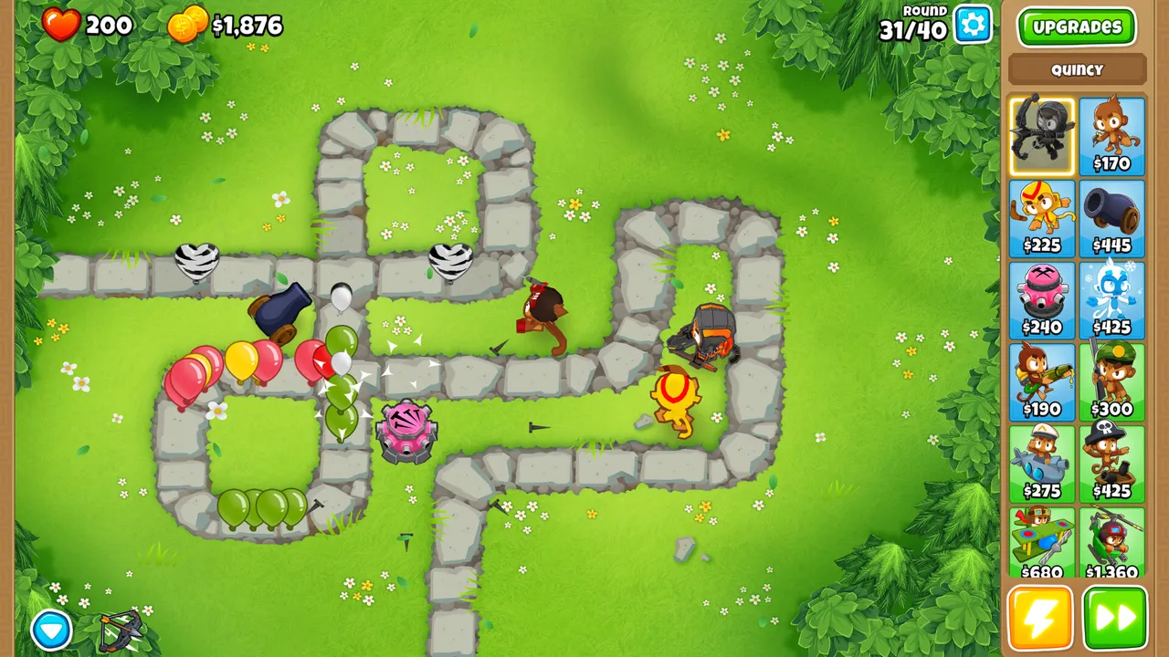 Bloons TD 6 at round 31 of 40 on a grassy stone-path map with a cannon, a dart monkey and other towers popping bloons