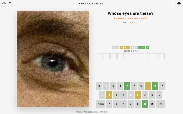 Celebrity Eyes #34 on a desktop after one guess: the photo zoomed out a step on a green eye, the guess in green, yellow and grey letters, and an on-screen keyboard