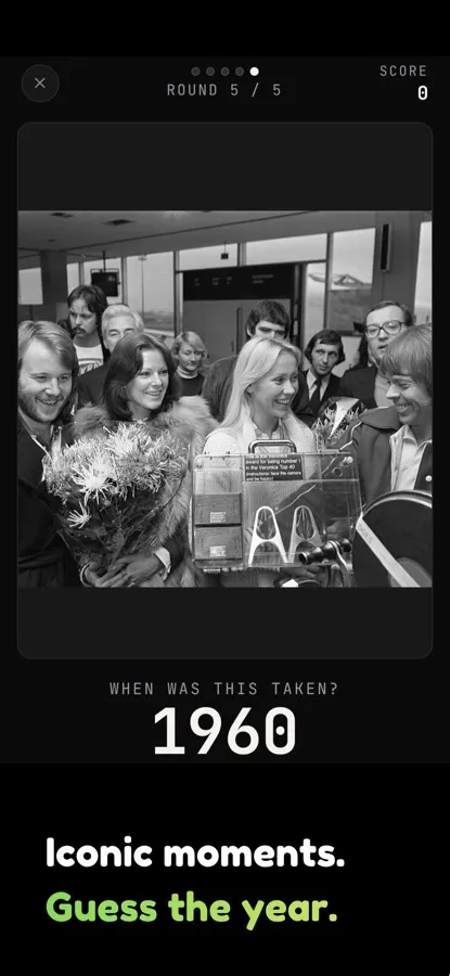 A Chronophoto round showing a black and white photo of a crowd at an airport and a year guess below it