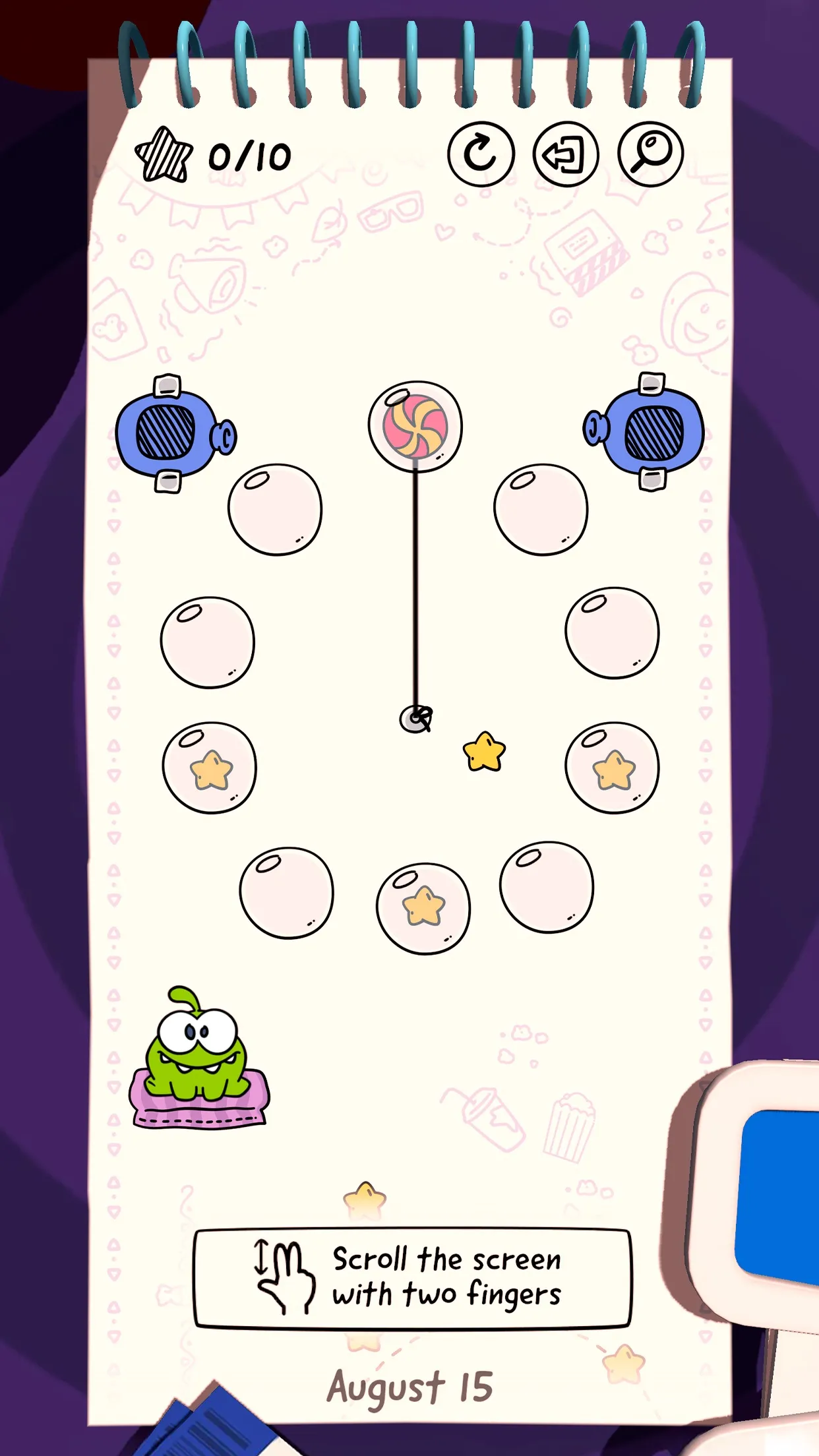 Cut the Rope Daily's August 15 level: candy on a rope above a ring of bubbles with stars, two air cushions, and Om Nom waiting at the bottom left of a notebook page