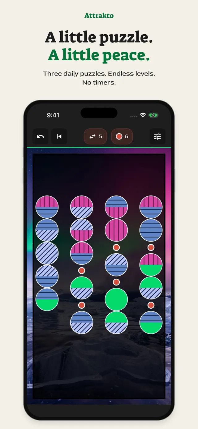An Attrakto board on an iPhone: four columns of two-toned pieces with red Repulsor dots between mismatched neighbours