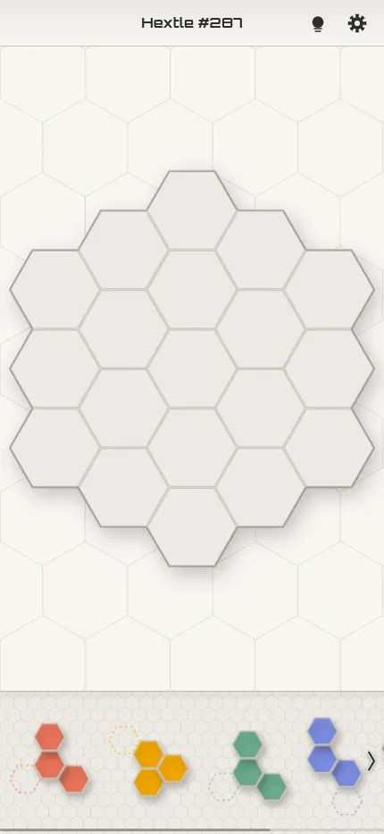 Hextle on a phone held upright, the honeycomb board above a scrolling tray of polyhex pieces