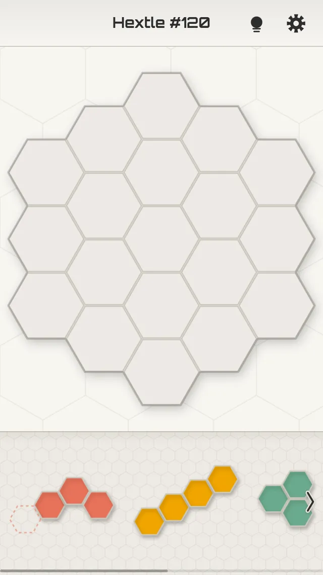 Hextle #120 in play: an empty 19-cell honeycomb board with red, yellow and green polyhex pieces waiting in the tray below