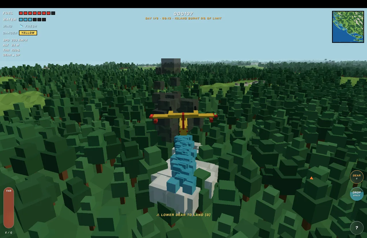 The Kanader water bomber dropping a column of blue water onto a burning building in a forest