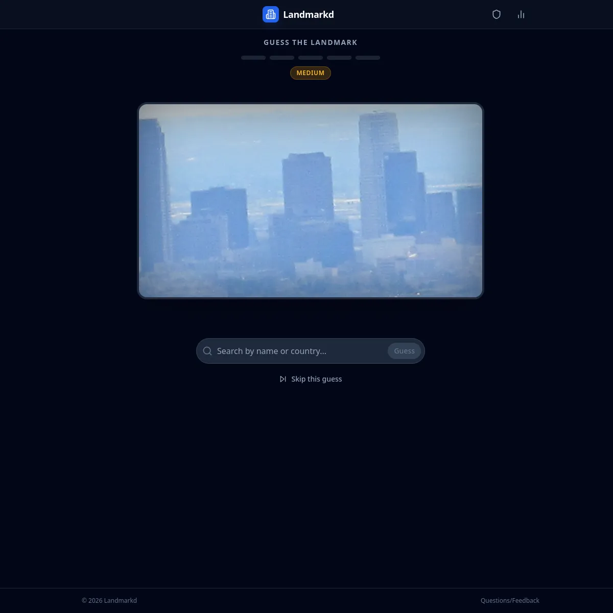 Landmarkd Guess the Landmark: a Medium difficulty badge and five guess markers above a blurred photo of a city skyline, with a Search by name or country box, a Guess button and a Skip this guess link.