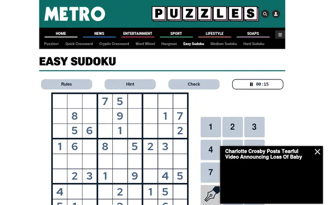 Metro's Easy Sudoku page with a partly filled 9 by 9 grid, Rules, Hint and Check buttons, a timer and the number pad; a news video box covers the lower part of the pad