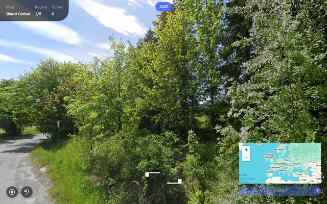 A PlaceGuessr round in play: a Street View country lane among trees, with round 1 of 5, a 2:52 timer and the world map for the pin in the corner