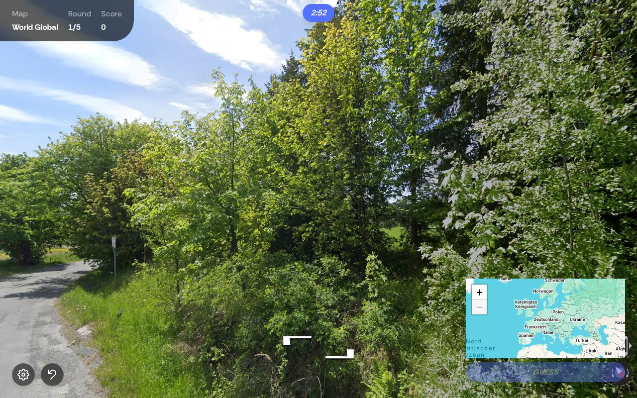 A PlaceGuessr round in play: a Street View country lane among trees, with round 1 of 5, a 2:52 timer and the world map for the pin in the corner