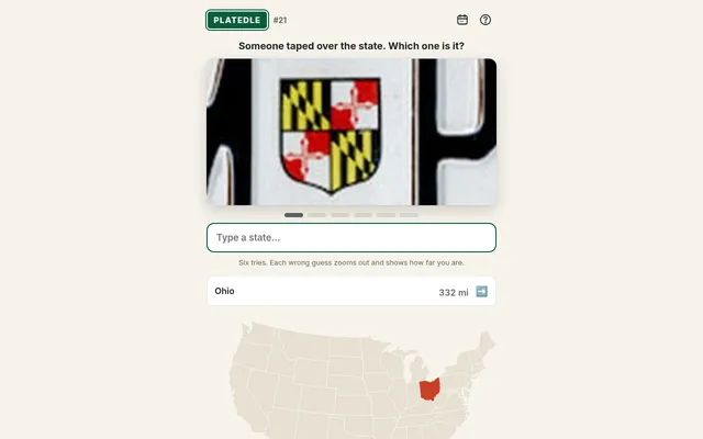 Platedle plate #21 after one wrong guess: a close-up of the Maryland flag shield on a plate, Ohio listed as 332 miles off with an arrow east, and Ohio shaded on the US map