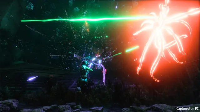 Returnal: Selene firing green beams at a huge glowing red tentacled creature in a dark overgrown biome