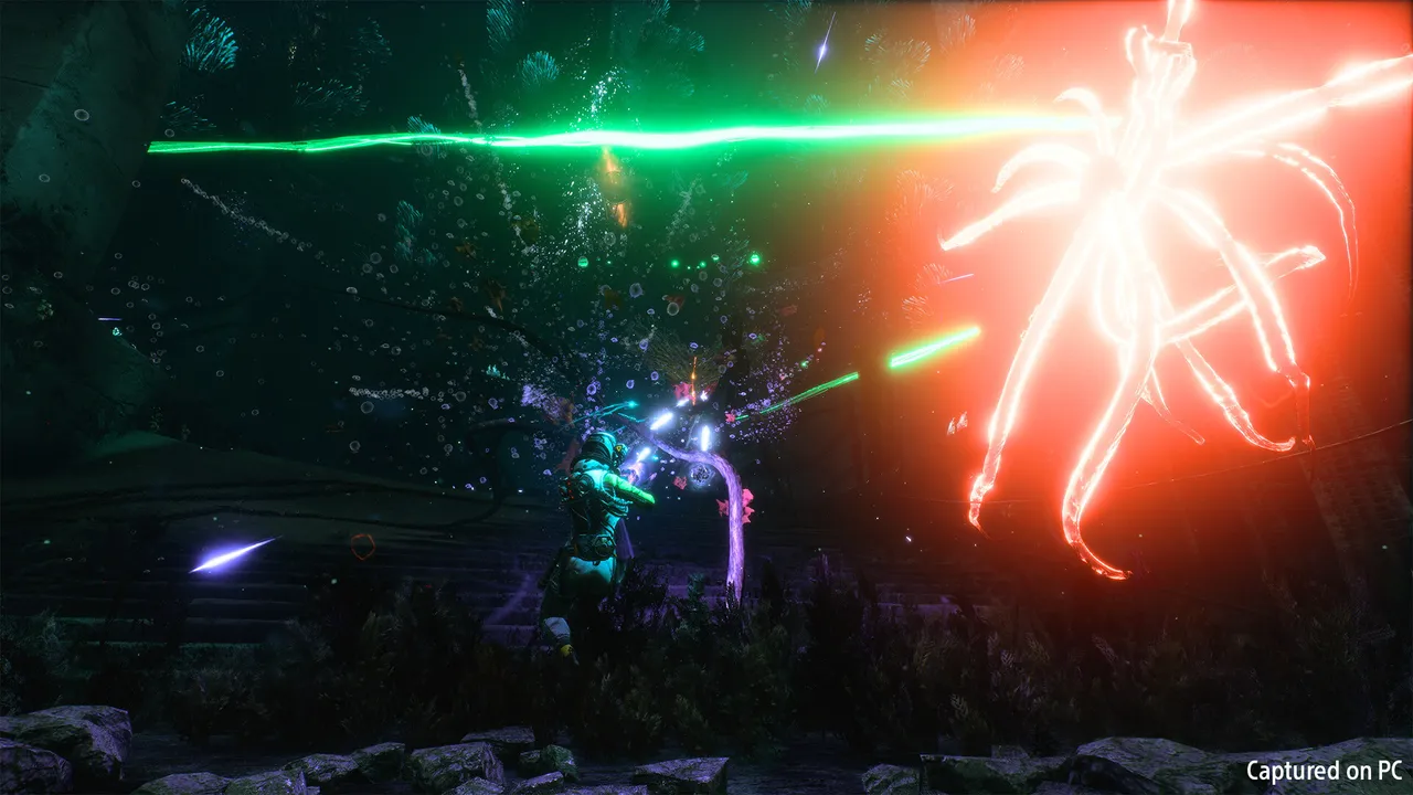 Returnal: Selene firing green beams at a huge glowing red tentacled creature in a dark overgrown biome