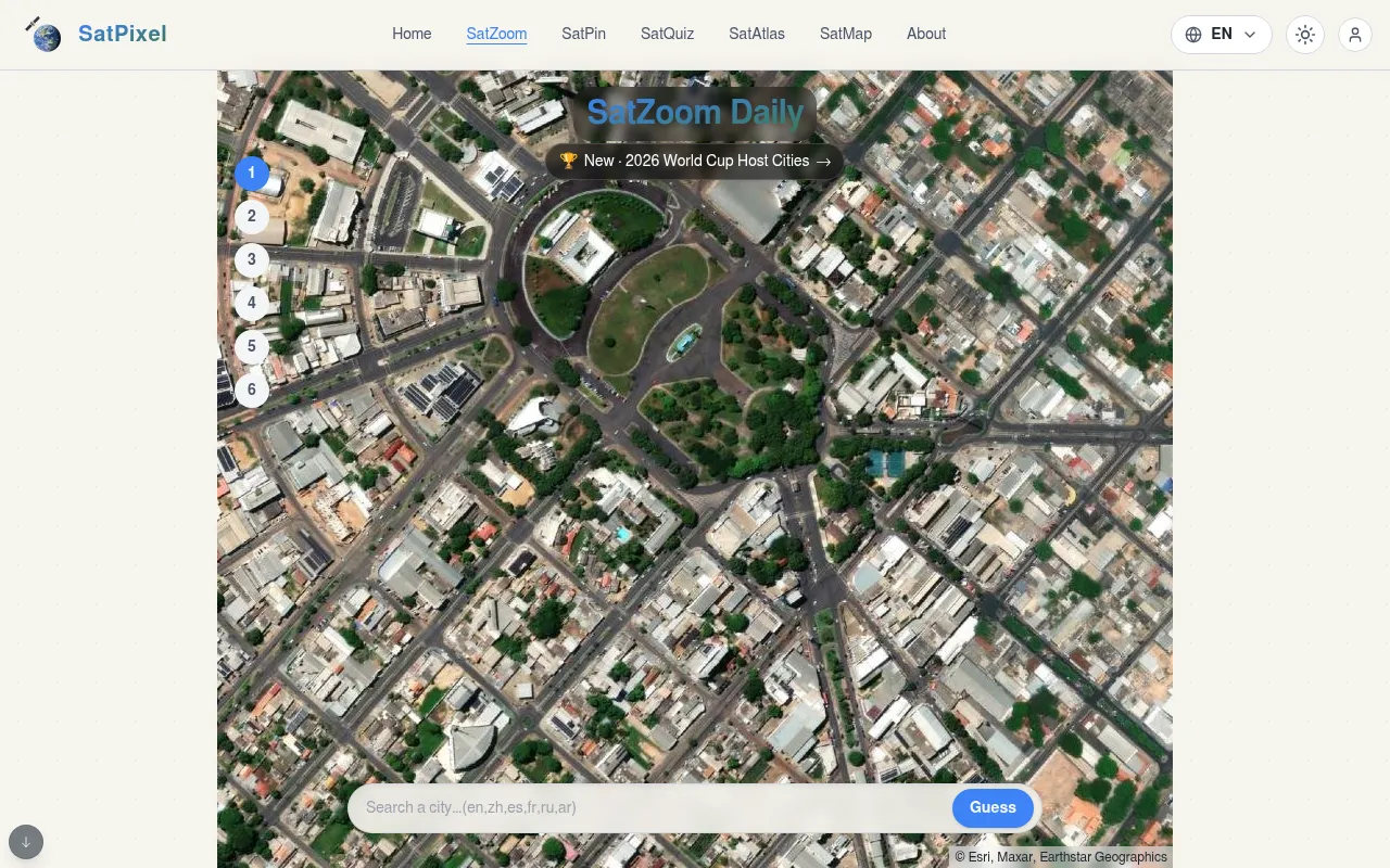SatZoom Daily on 21 October 2026: today's close satellite view of a city square ringed by a road, with six numbered view buttons and the city search box