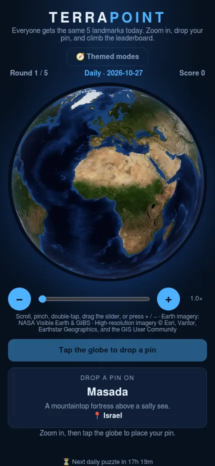 TerraPoint at phone size: the satellite globe over Africa and the clue card asking for a pin on Masada, a mountaintop fortress in Israel