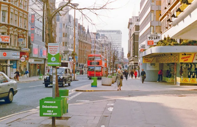An older London street scene with a red double-decker bus and black cab, the example photo from WhenTaken's home page