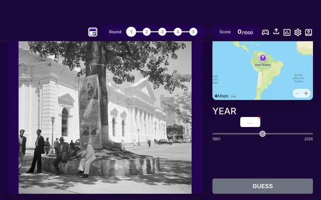WhenTaken's daily game on 27 October 2026, round 1 of 5: a black and white street photo with a white colonnaded building, a pin on the world map and the 1860 to 2026 year slider