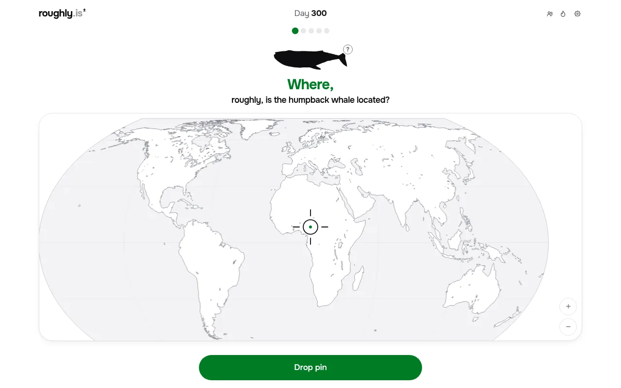 Where? roughly. Day 300 on desktop: a humpback whale silhouette above a blank world map with a crosshair in the middle and a green Drop pin button