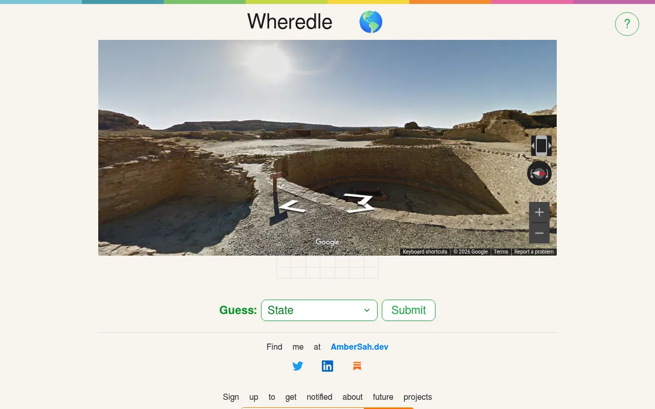 Wheredle on a desktop: today's Street View scene of stone ruins in a desert canyon above the guess grid, State drop-down and Submit button