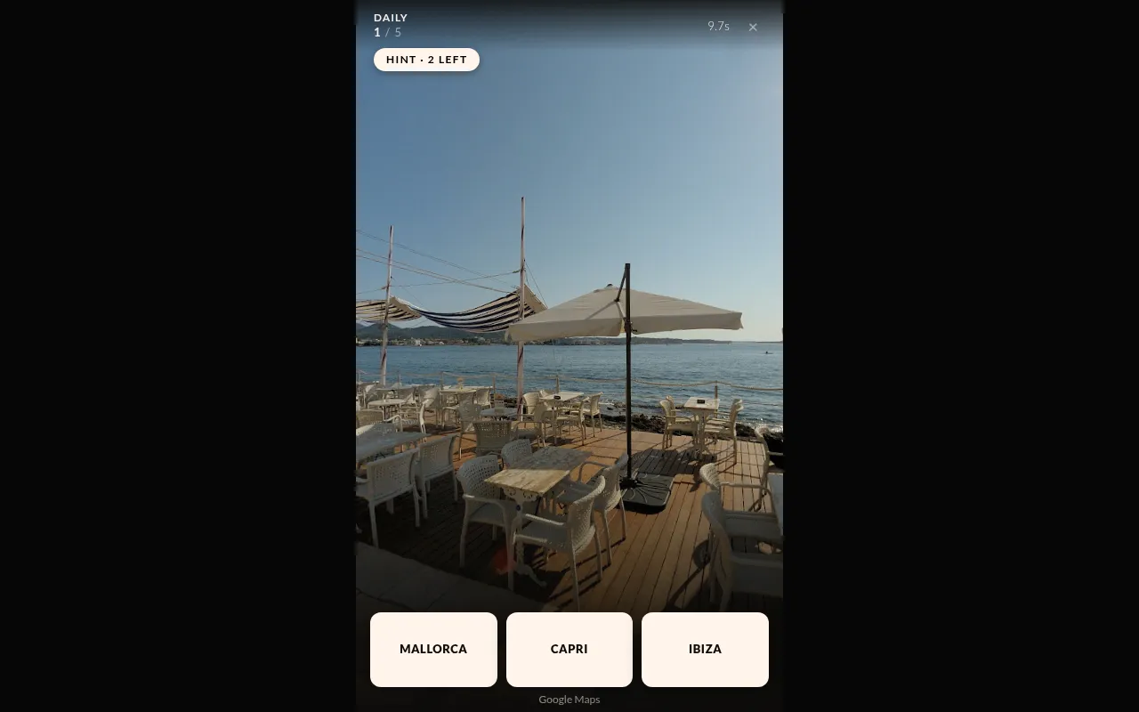 Wild Space Atlas Daily for 29 October 2026, place 1 of 5: a Street View seaside terrace with white chairs and parasols, a hint button (2 left), and three choices: Mallorca, Capri and Ibiza
