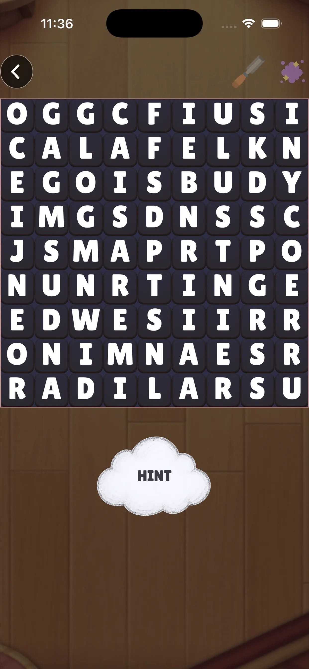A Wordpeek puzzle in the iPhone app: a 9 by 9 grid of letter tiles over a hidden picture, with a Hint cloud below